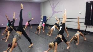 On of our assistants working with our jazz 2 girls on their leg extensions.  Lengthen through the backs of those legs girls! 